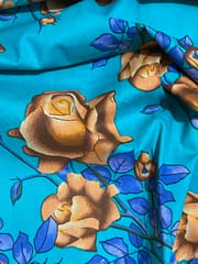 Light blue colored cotton fabric with brown flowers print
