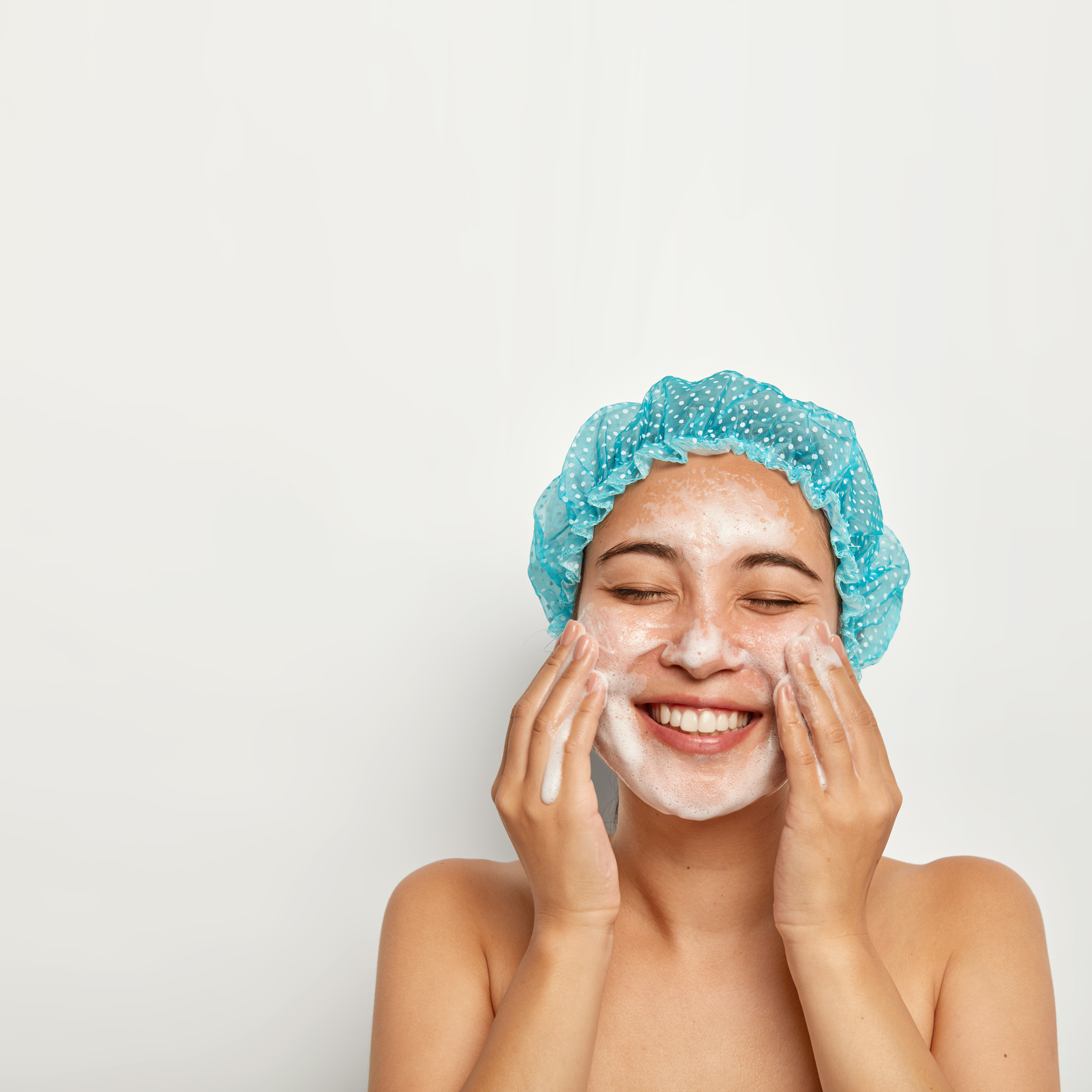flawless-purity-skin-vertical-image-pretty-woman-washes-face-enjoys-cold-water-has-foam-skin-smiles-joyfully-keeps-eyes-closed-takes-care-personal-hygiene-wellness-concept.jpg