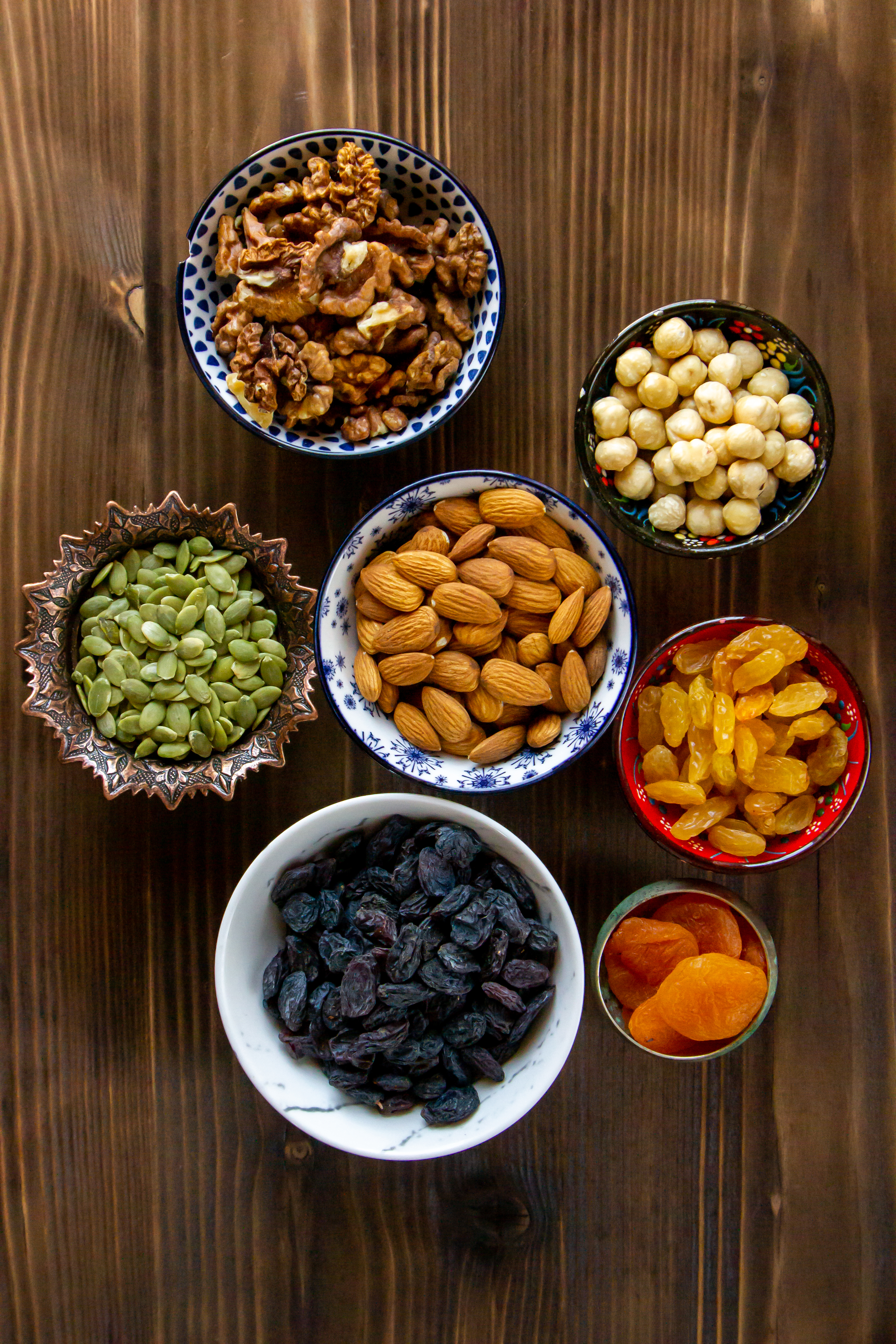 top-view-mix-nuts-dried-fruits-almonds-raisins-pumpkin-seeds-with-dried-apricots-table